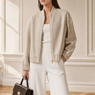 Gold bomber jacket front detail showing zip closure and ribbed collar