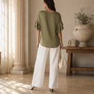 Olive green ruffle-sleeve top by Lord & Taylor Heritage, full-length side view on model