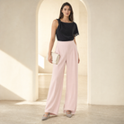 Blush pink wide-leg trousers on model full length by Lord & Taylor Heritage