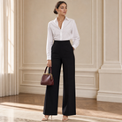 Black high-waisted wide-leg trousers on model, full-length view by Lord & Taylor Heritage