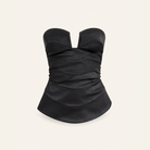 Black satin bustier top with dropped peplum hem, flat product shot