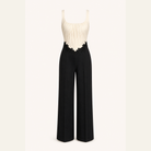 Two-tone jumpsuit with cream bodice and black trousers, flat product shot