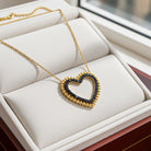 Yellow gold heart pendant necklace with black diamonds, front view by Lord & Taylor