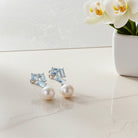 White gold pearl and blue topaz cluster dangle earrings by Lord & Taylor, front view